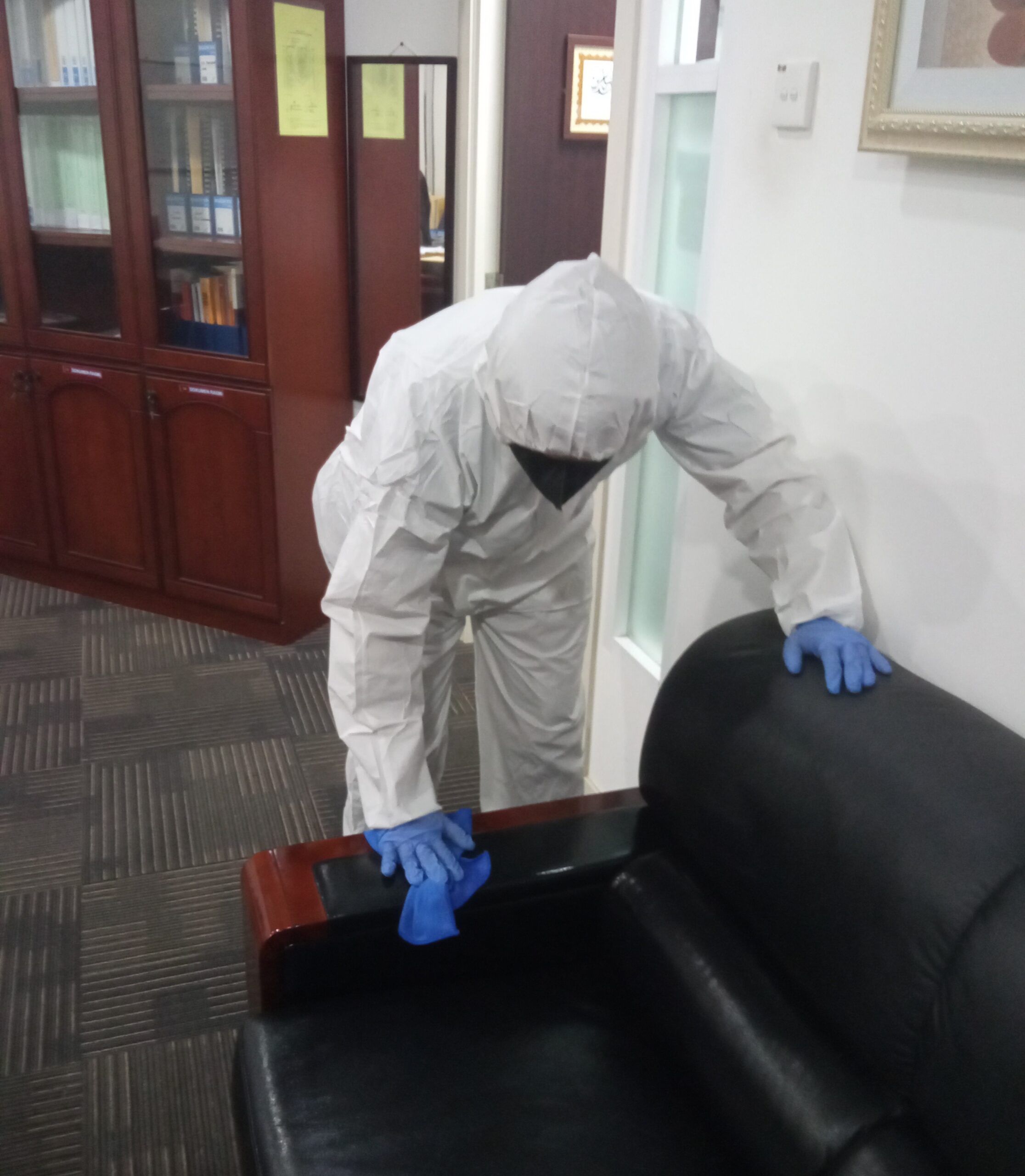 A man in white PPE is sanitizing the chair during Covid-19 Disinfection & Sanitisation Service in Selangor.