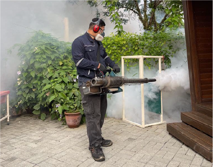A man is fogging the mosquito as Envirocon offers pigeon & mosquito pest control services.